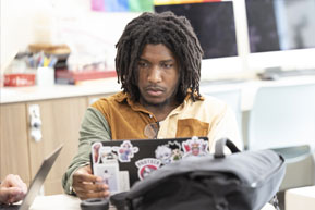 A student focuses on his assignment. Links to Gifts of Cash, Checks, and Credit Cards