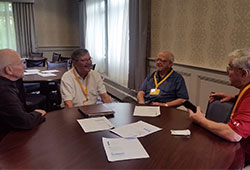 A group of me speaking during a meeting